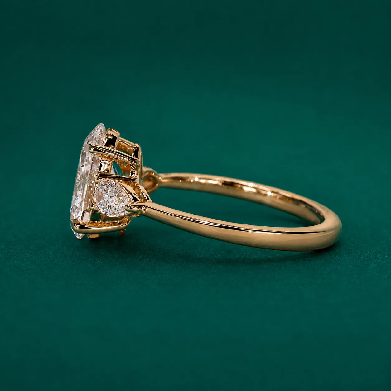 Oval diamond ring with side pear shaped diamonds